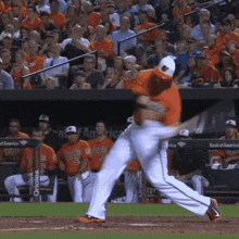 a baseball player is swinging his bat at a pitch during a game