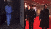 a man in a black coat walking down a red carpet