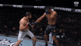 two men are fighting in a cage with a sign that says true classic