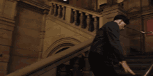 a man is walking down a set of stairs next to a sign that says ex