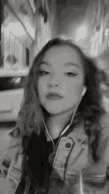 a black and white photo of a woman wearing ear buds