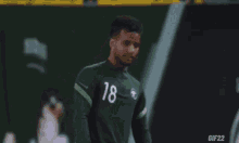 a soccer player with the number 18 on their jersey