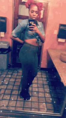 a woman is taking a picture of herself in a bathroom mirror
