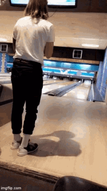 a person standing on a bowling alley with imgflip.com written on the bottom