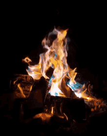 a fire with a blue flame coming out of the top
