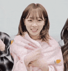 a girl is wrapped in a pink blanket that says ' i love you ' on it