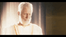 a man with a beard and a white robe