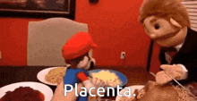 mario and placenta are sitting at a table eating food