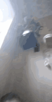 a person is standing on a set of stairs in a room with smoke coming out of the windows .