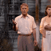 a man in a white shirt is talking to a woman