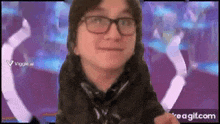 a man wearing glasses is making a funny face