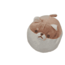 a brown and white stuffed animal with a dog 's face on it is sitting on a white surface .