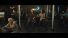 two women are standing next to each other in front of a bar .