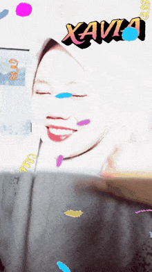 a woman wearing a hijab is surrounded by confetti and the word xava is above her