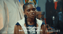 a woman says " you 're a glitch but you 're my glitch " in front of a poster for ironheart