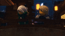 a couple of lego figures standing next to each other on a balcony