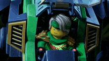 a ninjago character is sitting in a green vehicle