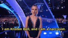 a woman stands in front of a crowd and says i am kristen bell
