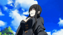 a woman in a black dress stands in front of a blue sky with clouds