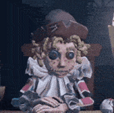 a clown is sitting at a table wearing a pirate hat and holding a book .