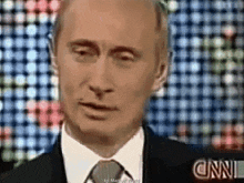 a man in a suit and tie is talking on cnn television