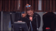 a woman is riding an elliptical machine in a gym