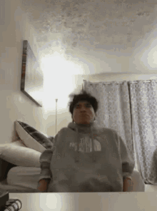 a man wearing a hoodie that says the north face on it