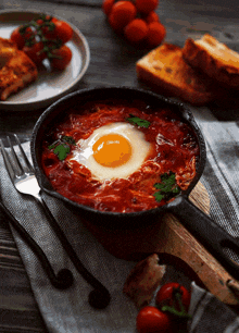 a frying pan filled with tomato sauce and a fried egg