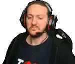 a man wearing headphones and a microphone looks at the camera .