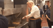a man in a white shirt and tie is cooking food in a kitchen