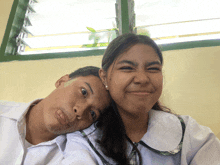 a boy and a girl are posing for a picture and making funny faces