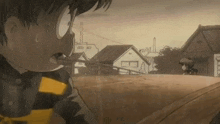 a cartoon character is standing in front of a row of houses in a town .