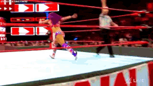 a woman in a wrestling ring with the word live on the bottom right