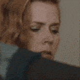 a close up of a woman 's face with a ring on it