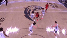a basketball game is being played on a court that says sn on it