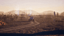 a jeep driving down a dirt road in the desert