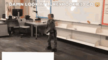 a boy is dancing in a classroom with the words damn look at lukeypookie10 go