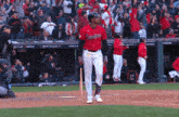 a baseball player wearing a red and white uniform with the team name indians on it