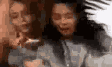 a blurry picture of two people taking a selfie with their phones .
