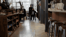a man in a wheelchair is walking down a hallway in a store