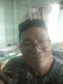 a man wearing glasses and headphones is taking a selfie in a room .