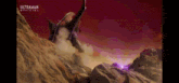 a monster is standing on top of a pile of rocks in a desert .