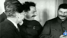 a black and white photo of three men with the number 2 on the bottom