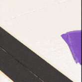 a purple piece of paper is laying on a tiled floor