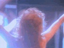 a close up of a woman 's back with her arms outstretched .