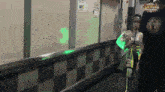 a person walking down a hallway with a sign on the wall that says ' samurai ' on it