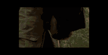 a bald man is laying in the dirt with his mouth open .