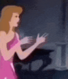 a woman in a pink dress is standing in front of a piano in a dark room .
