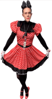 a woman wearing a minnie mouse costume with a name tag on her neck