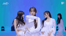 a group of girls are dancing in front of a blue background that says play color on it